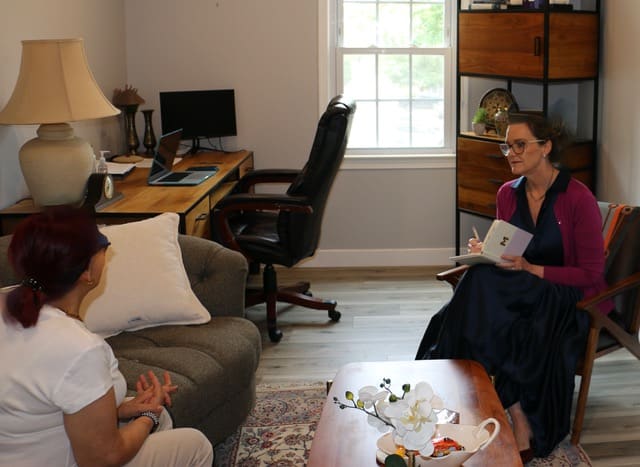 A provider talking with a patient in a calm office
